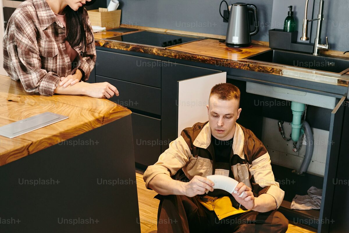 Hands working with tools on a wooden workbench